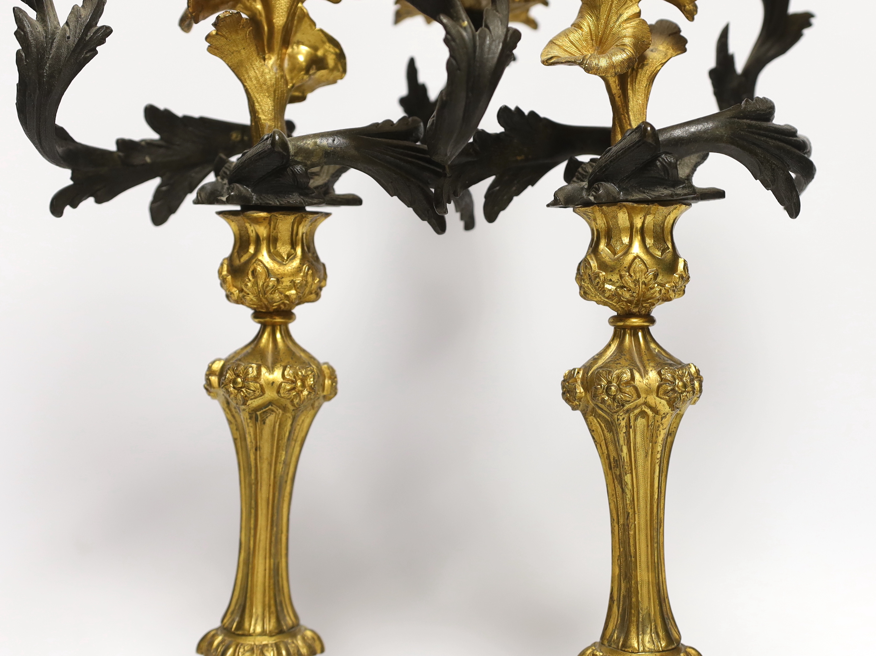 A pair of Victorian bronze and ormolu two branch candelabra, 39cm
